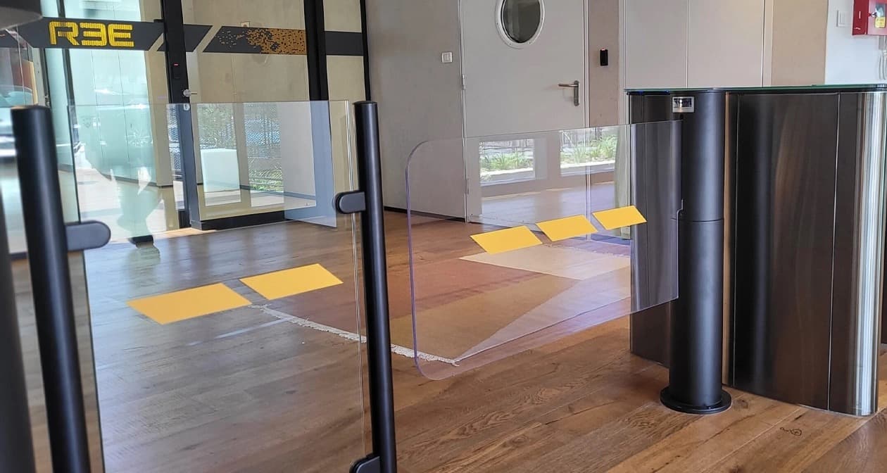 An ADA-width swing gate paired with a turnstile lane bank